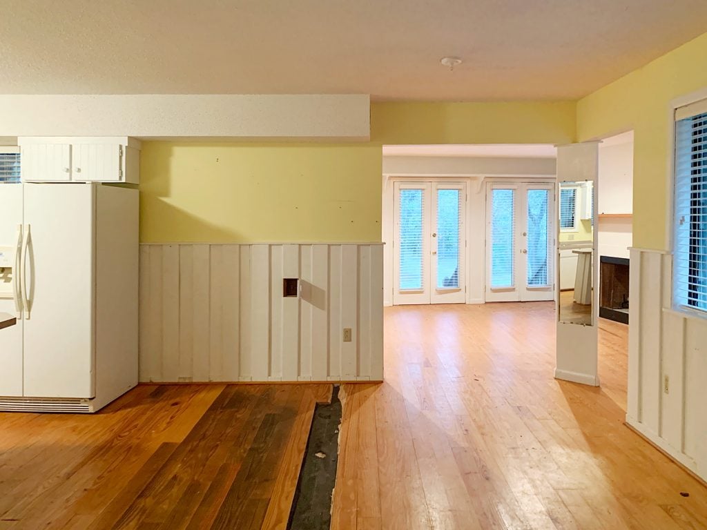 Before photo of kitchen with wide open doorway into former living room