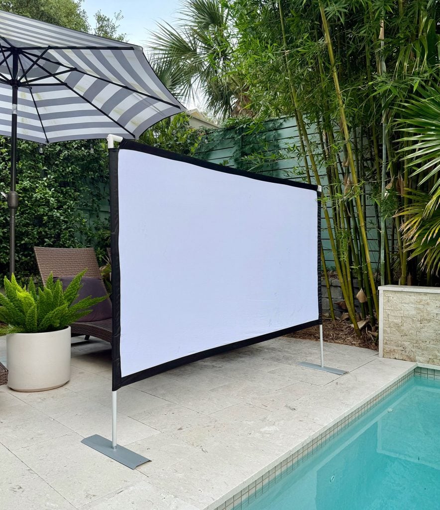 Collapsible Screen Set Up By Pool For Outdoor Movie Night