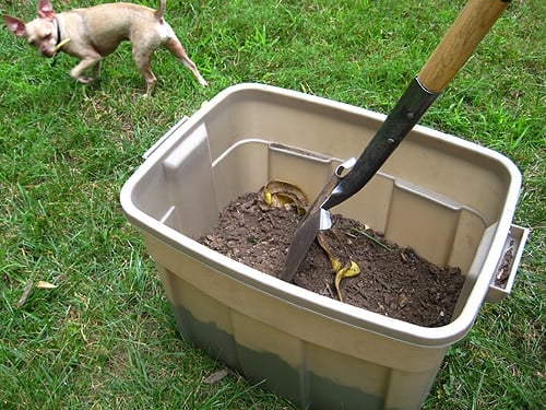 compoststep6 stirring homemade compost bin with shovel