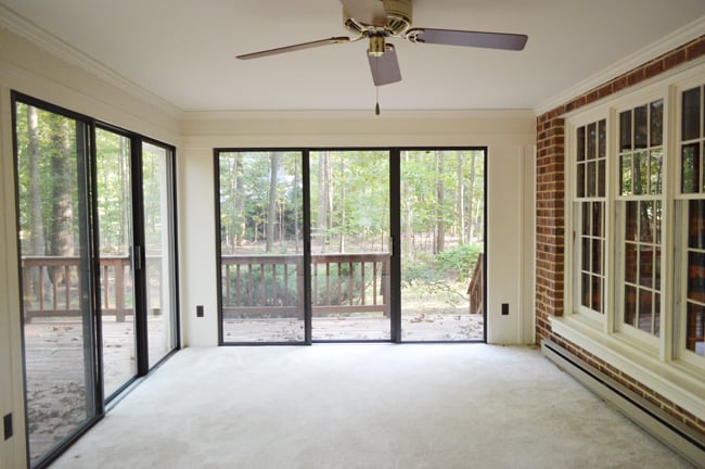 Before Photo Of Enclosed Porch With Carpet And Sliding Glass Doors