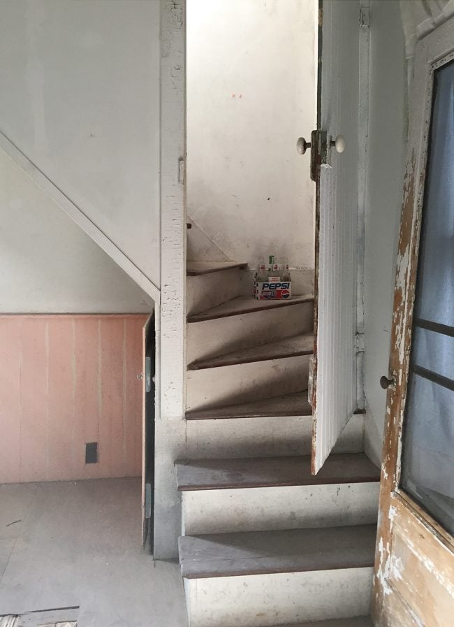 Before Photo of Rear Staircase In Beach House Downstairs