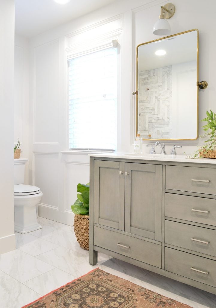 Master Bathroom Update With Gray Vanity Installed With Brass Mirror