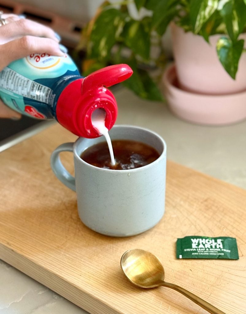 Adding Coconut Creamer To Mug of Pour Over Coffee